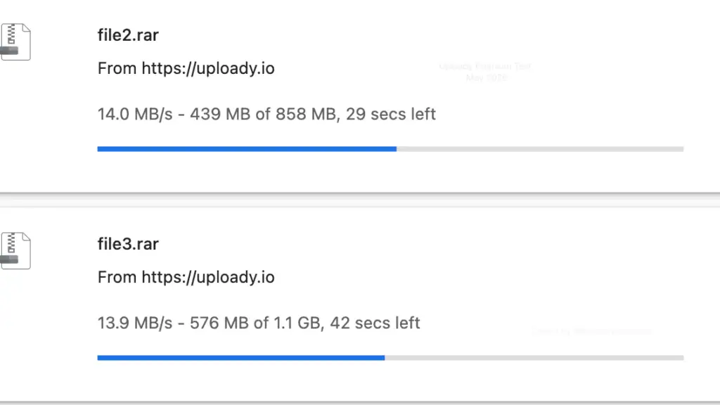 Two parallel file downloads in Google Chrome from uploady.io holding steady at 14.0 MB/s and 13.9 MB/s.